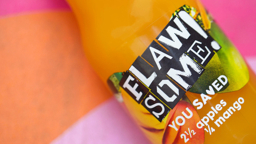 Flawsome - Apple and mango juice in focus whilst a pink and orange background is out of focus.
