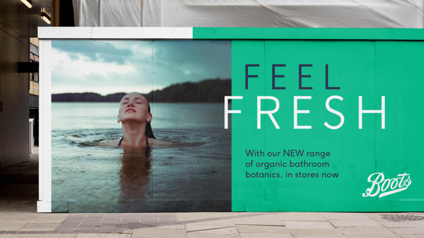 "Boots 'Feel fresh' advert displayed on advertisement hoarding on a construction site."