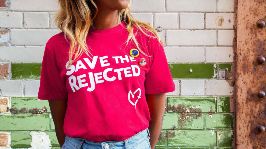 A lady wearing a pink t-shirt with the caption 'save the rejected'