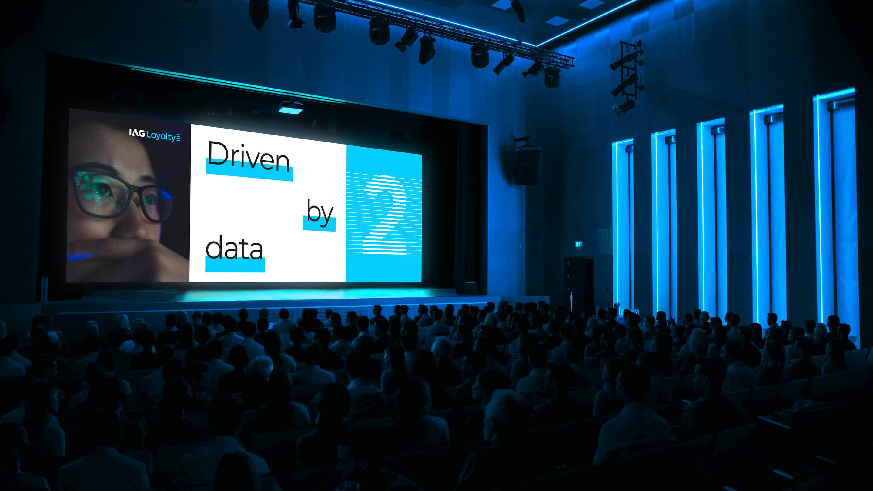 The words 'Driven by data' being displayed at what looks like a presentation at a large event.
