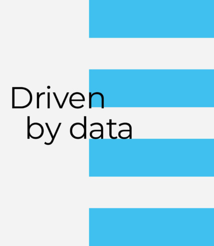 IAG - the word 'driven by data' displayed on a grey and light blue striped background.