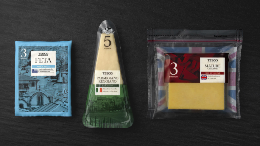 "Packages of Tesco cheeses: Feta from Greece, Parmigiano Reggiano from Italy, and Mature Cheddar from Britain, set against a dark surface."