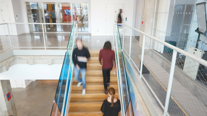 People going up and down a set of stairs with motion blur