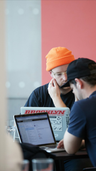 2 People doing work on laptops