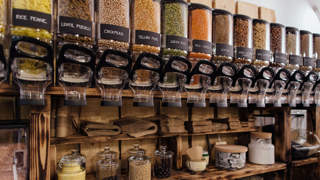 A collection of pantry supplies like chickpeas and penne inside of dropper containers.