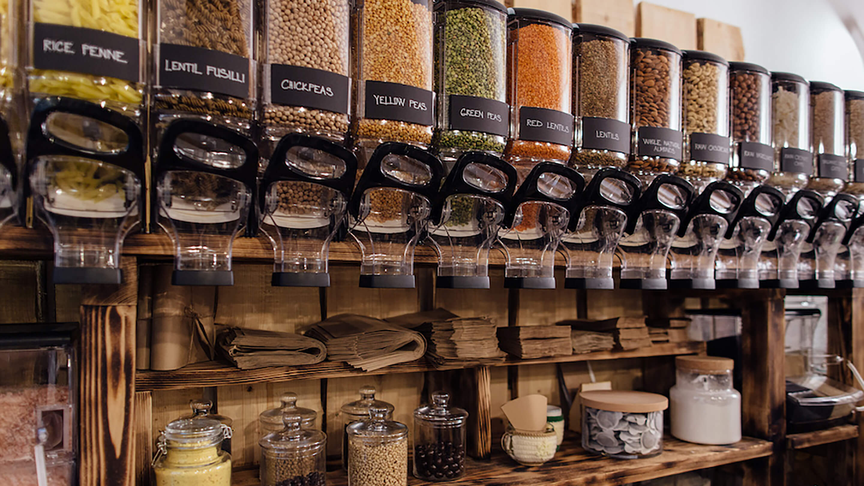 A collection of pantry supplies like chickpeas and penne inside of dropper containers.