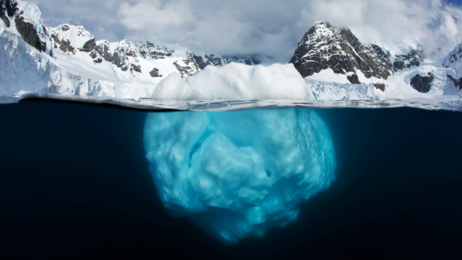 A glaciar shown beneath a body of water