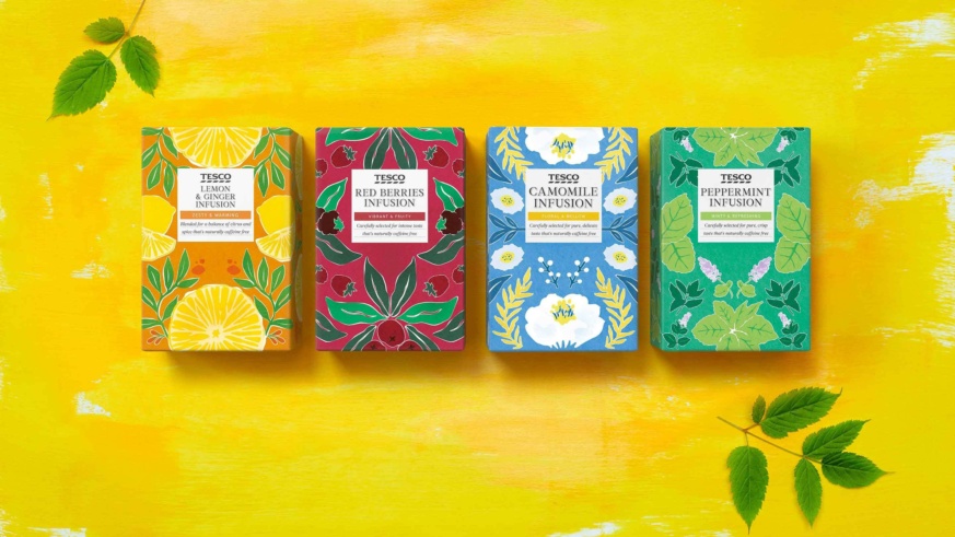 "Four boxes of Tesco tea infusions: Lemon & Ginger, Red Berries, Camomile, and Peppermint, on a bright yellow background with green leaves."