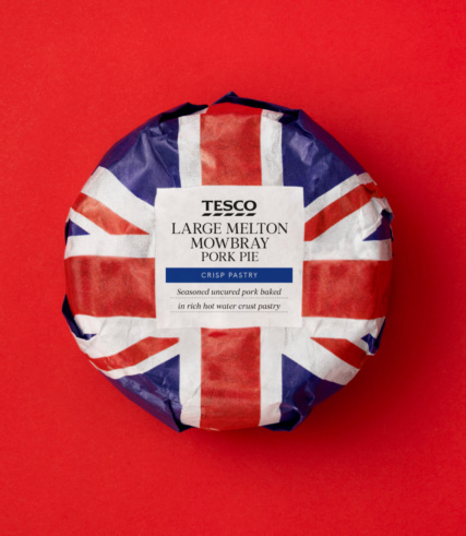 Tesco - a still packaged pork pie placed on a red background