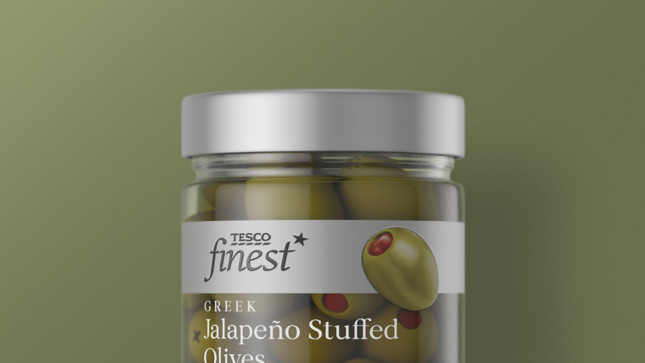 "A jar of Tesco Finest Greek Jalapeño Stuffed Olives with a silver lid."