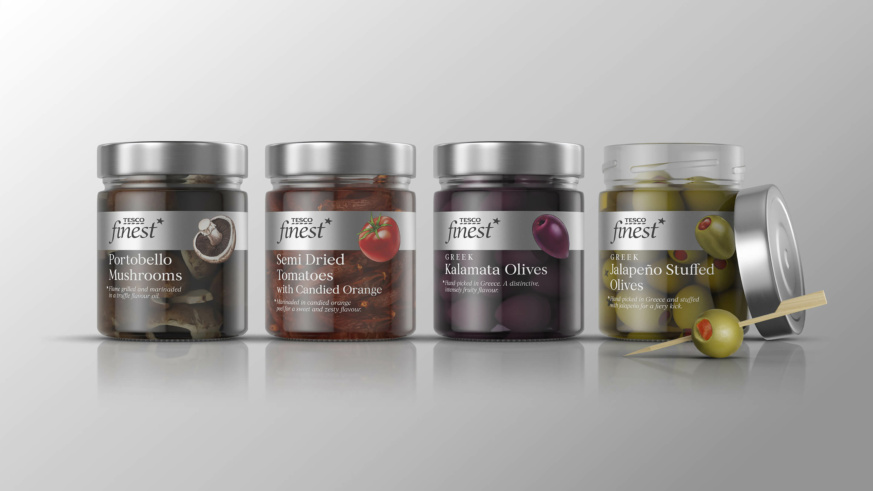 "A lineup of Tesco Finest jars containing Portobello Mushrooms, Semi Dried Tomatoes, Kalamata Olives, and Jalapeño Stuffed Olives."