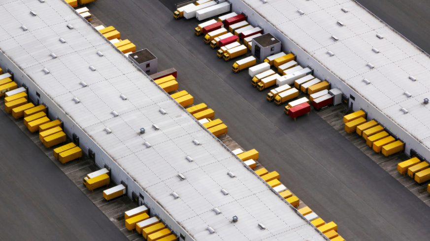 "Example of Cargill's photography princples showing an aerial view of a logistics hub with lorries parked alongside long warehouse buildings."